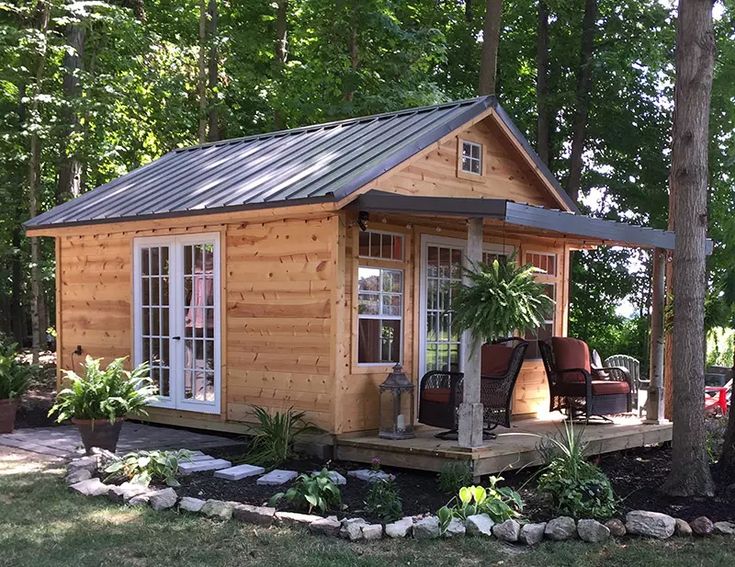 a small wooden cabin sitting in the middle of a forest