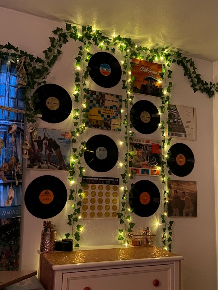 there is a wall covered with vinyl records and garlands on the side of it