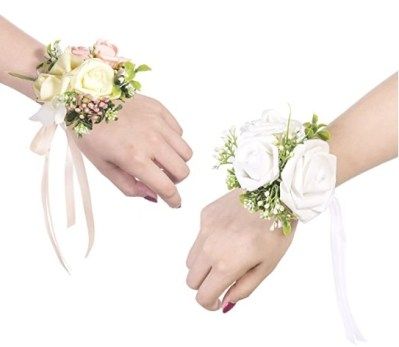 two brides hands holding bouquets of flowers