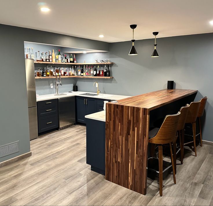 a kitchen with grey walls and wood flooring