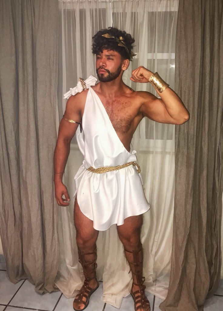 a man in roman garb posing for the camera with his hand on his hip