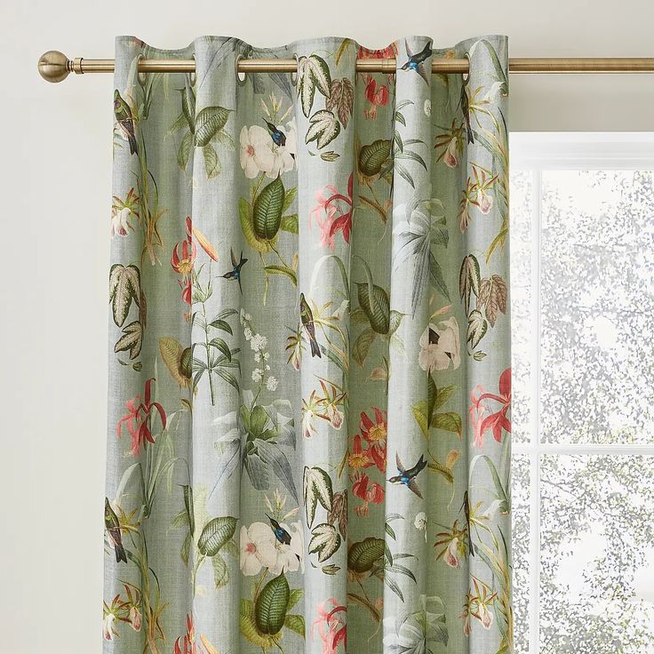 a curtain with flowers on it in front of a window