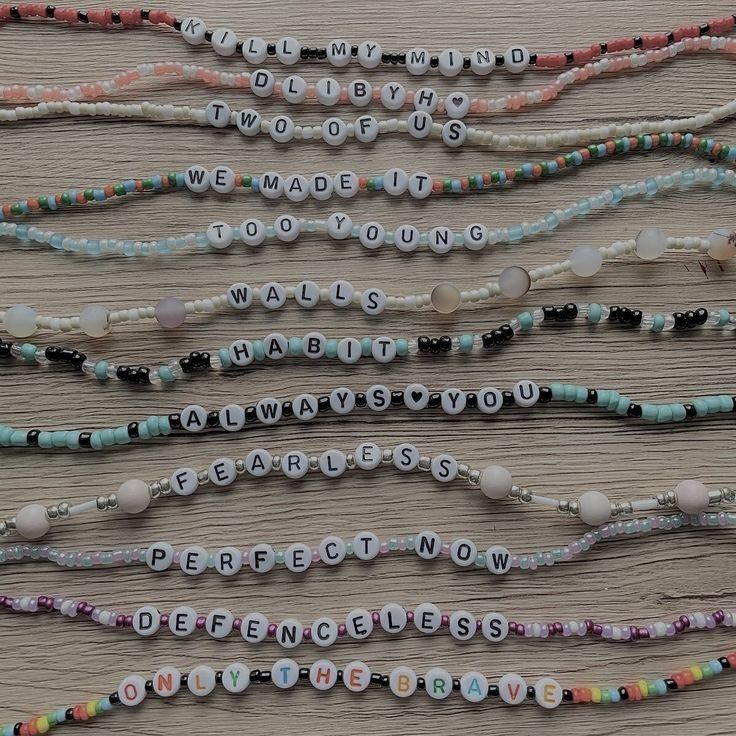 several beaded necklaces with words written on them