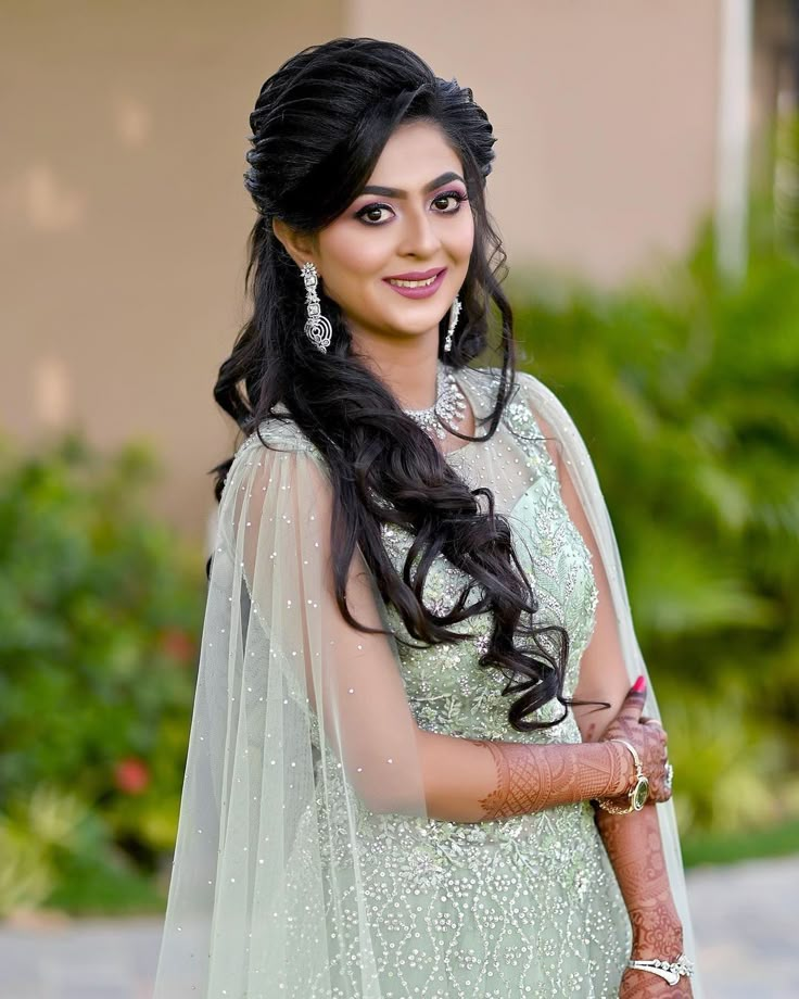 a woman in a green dress posing for the camera