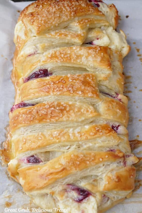 a close up of a pastry with cranberry toppings on it's side