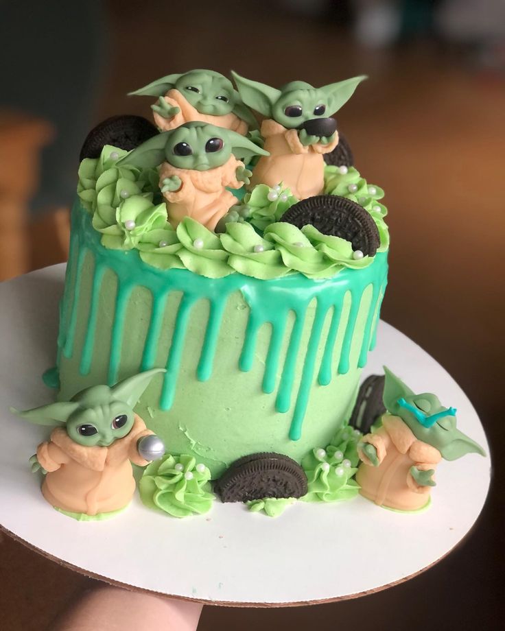 there is a green cake decorated with baby yoda's