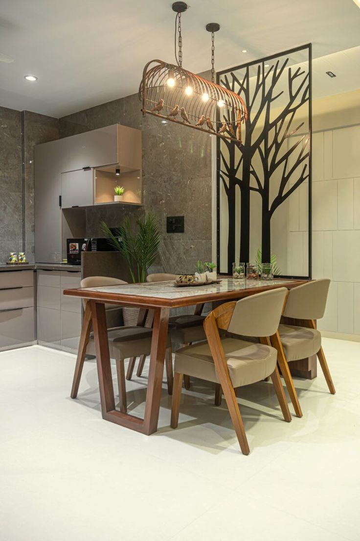 a dining room table with four chairs and a chandelier hanging from the ceiling