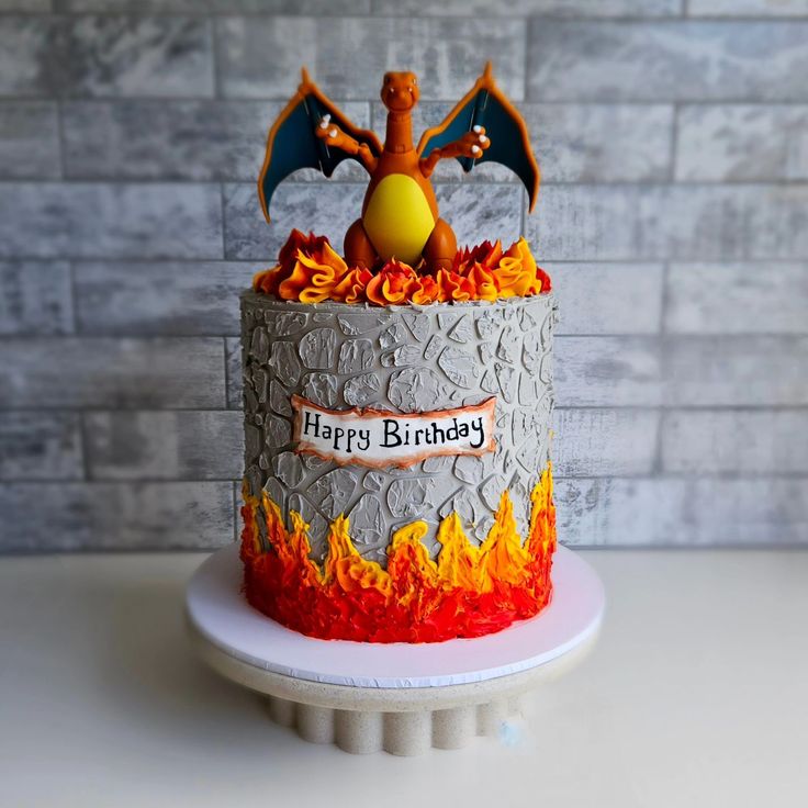 a birthday cake that is on top of a white plate and has flames around it