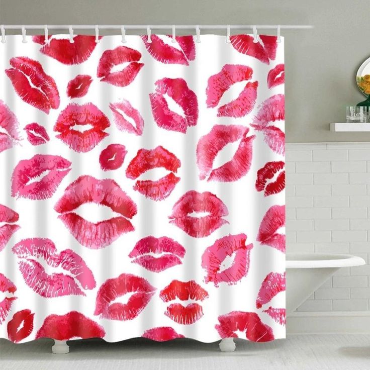 a shower curtain with red lipstick prints on it