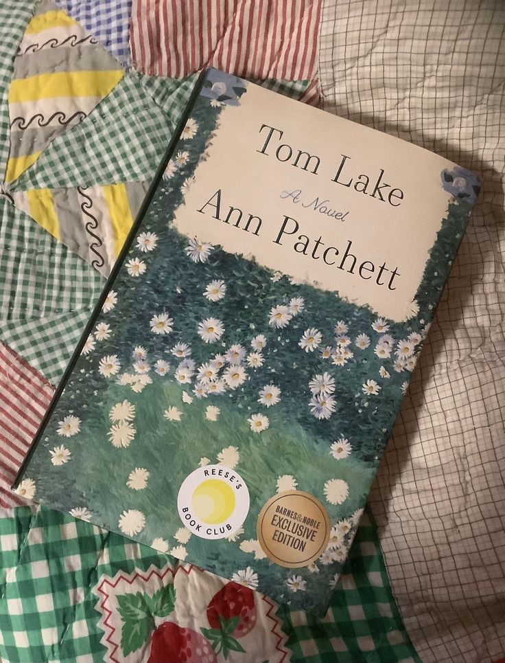 the book tom lake and ann patchett is laying on top of some quilts