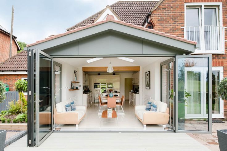 an open living room and dining area with sliding glass doors