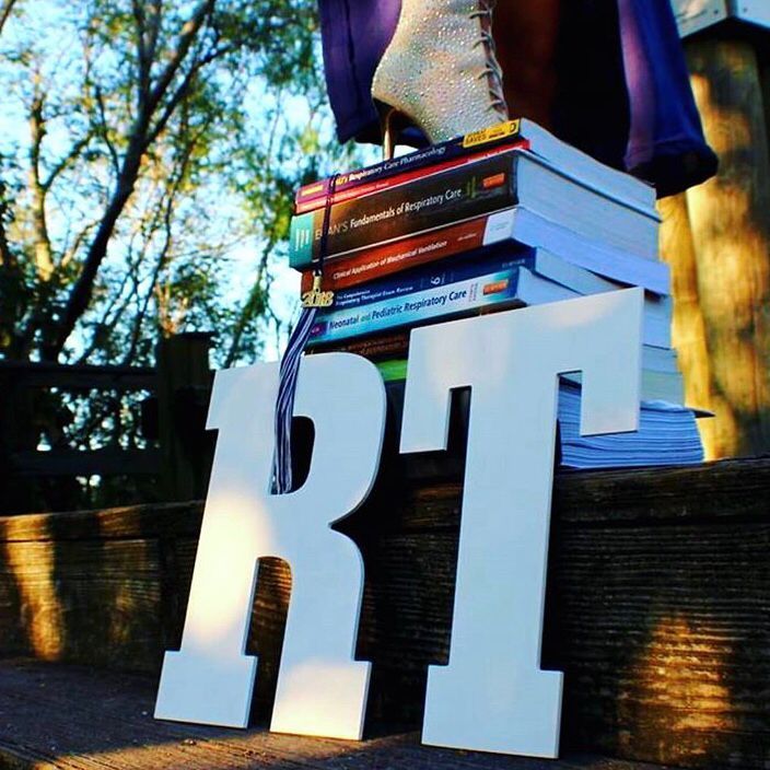 a stack of books sitting on top of a wooden sign that reads rtt next to a pile of books