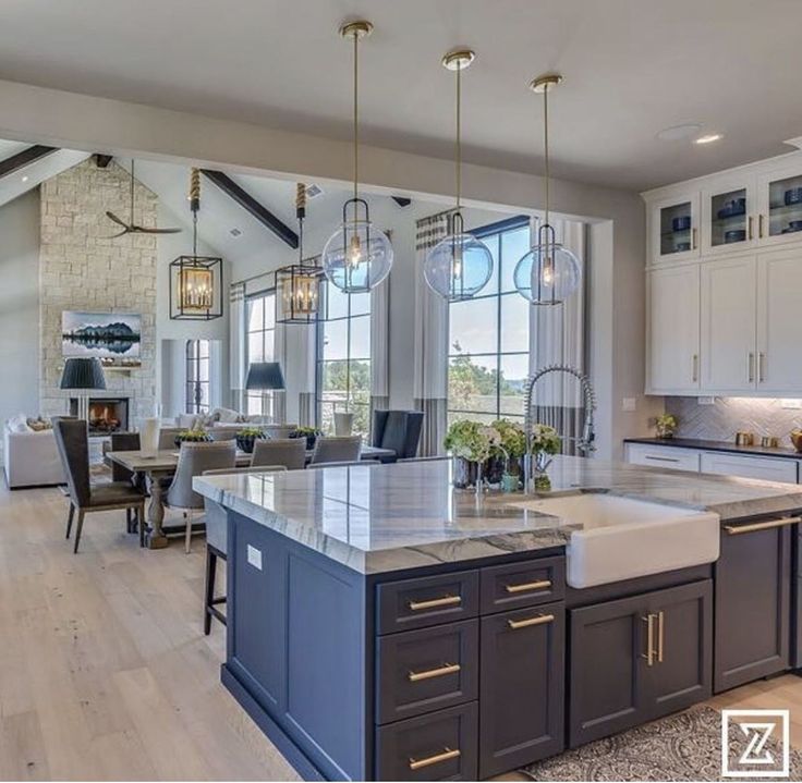 a large kitchen with an island in the middle and lots of counter space around it