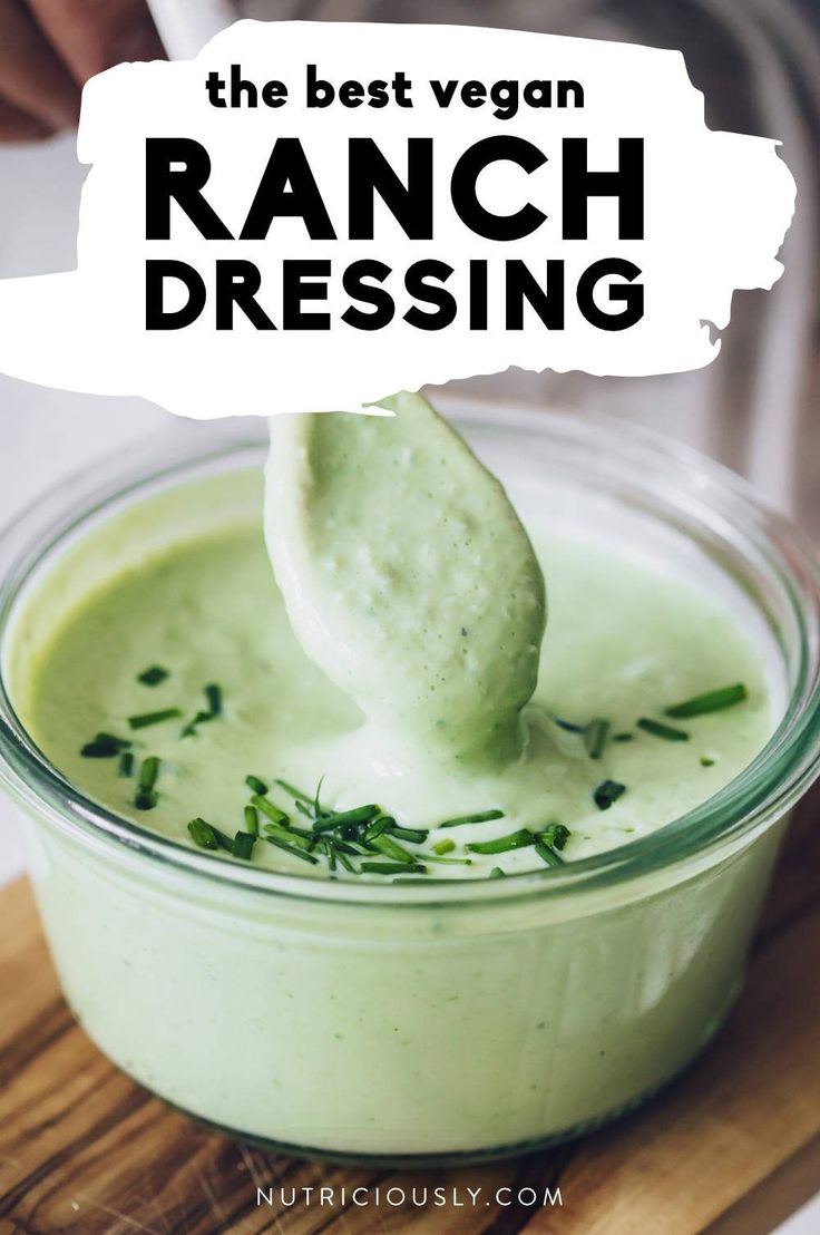 the best vegan ranch dressing is in a glass bowl with a spoon sticking out of it