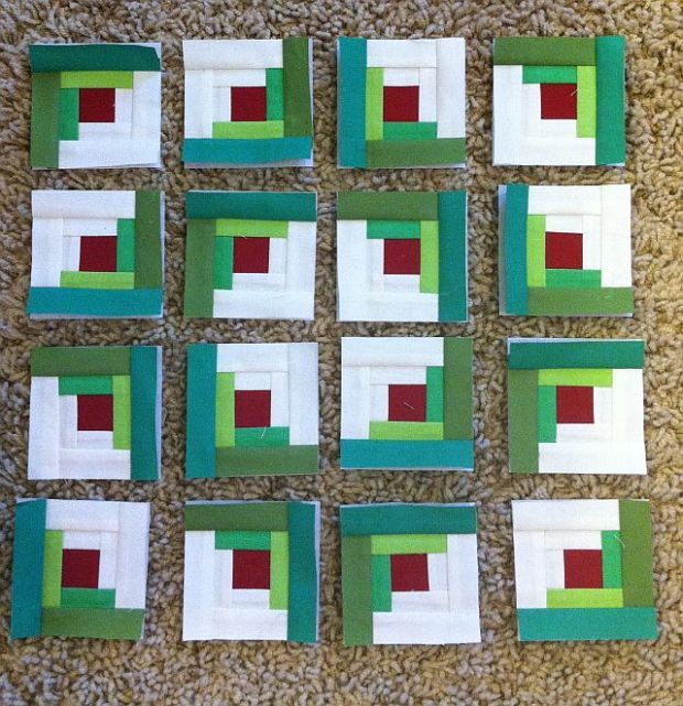 several squares are arranged on the floor with green and red squares in them, all lined up against each other