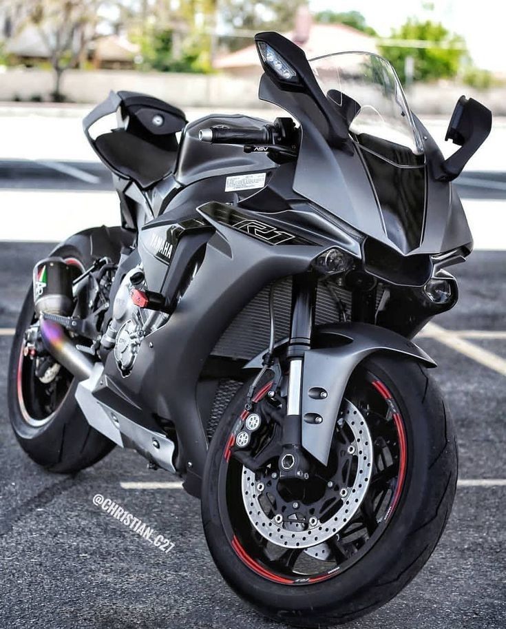 a black motorcycle parked in a parking lot