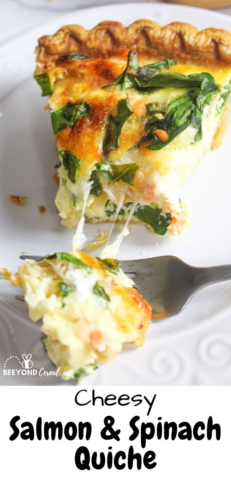 a slice of cheesy salmon and spinach quiche on a white plate