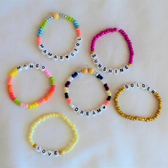 four bracelets with words written on them