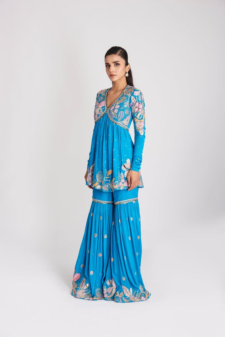 Kinfolk Cyan Blue applique embellished mulberry crepe kurta,gharara with organza dupatta .From Aisha Rao's Kinfolk collection. DELIVERY TIMEPlease allow 6-8 weeks for your outfit to arrive. FABRIC DETAILSCrepe Professional cleaning only. Festive Blue Unstitched Sharara, Blue Unstitched Sharara For Festive Occasions, Festive Blue Sharara With Straight Kurta, Blue Sharara With Straight Kurta For Festive Occasions, Unstitched Blue Sharara With Gota Work, Blue Embroidered Sharara For Designer Wear, Blue Unstitched Palazzo Set For Transitional Season, Blue Bohemian Palazzo Set With Zari Work, Bollywood Style Blue Chikankari Embroidered Palazzo Set