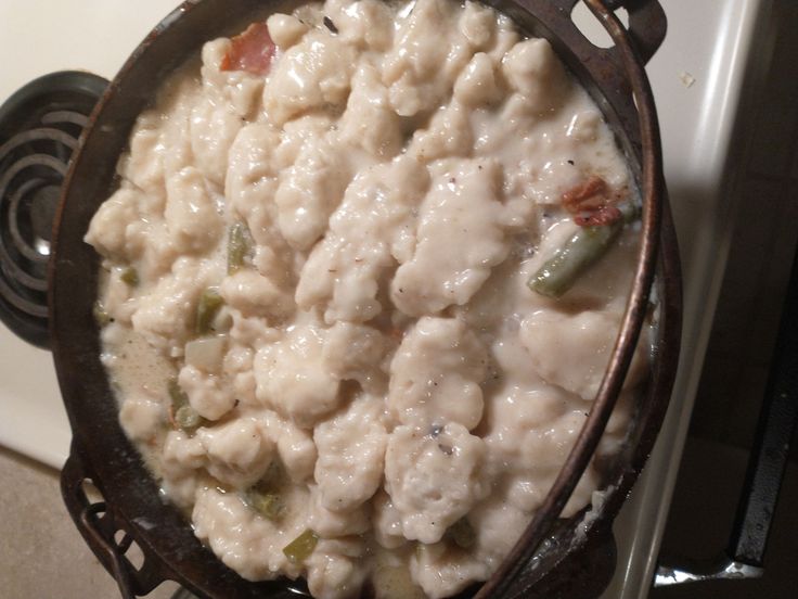 a pot filled with food sitting on top of a stove