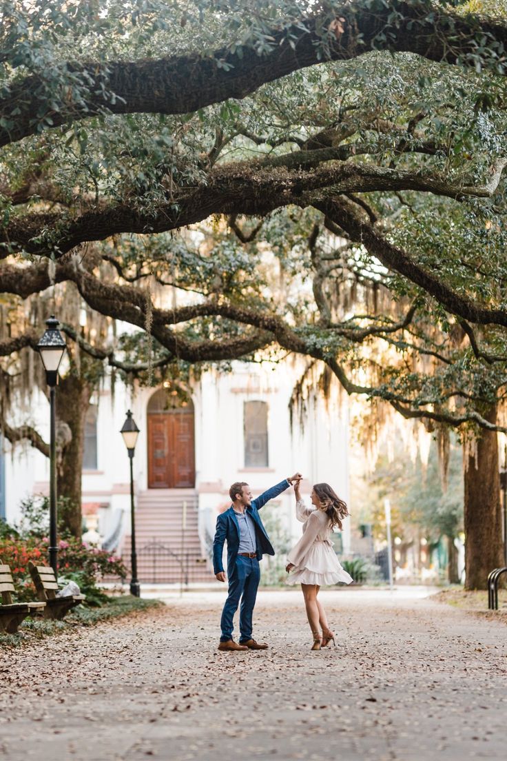 an engaged couple dancing under the trees in charleston, gautee island state park