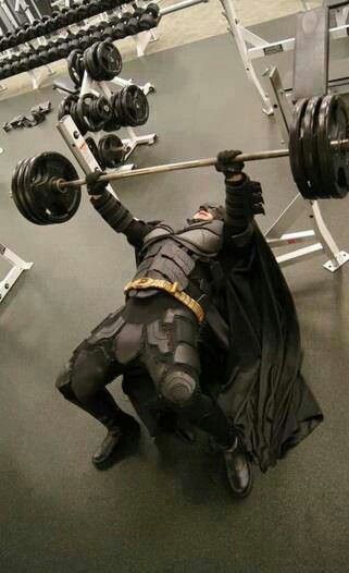 a man in batman costume lifting a barbell with the caption, my people need me but it's chest day