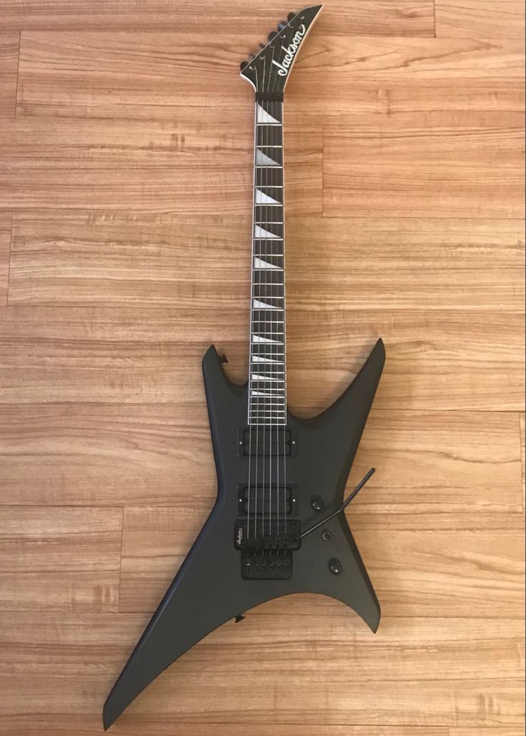 an electric guitar sitting on top of a wooden floor