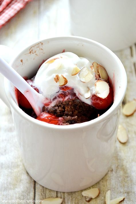 an ice cream sundae is in a white bowl with almonds on the side