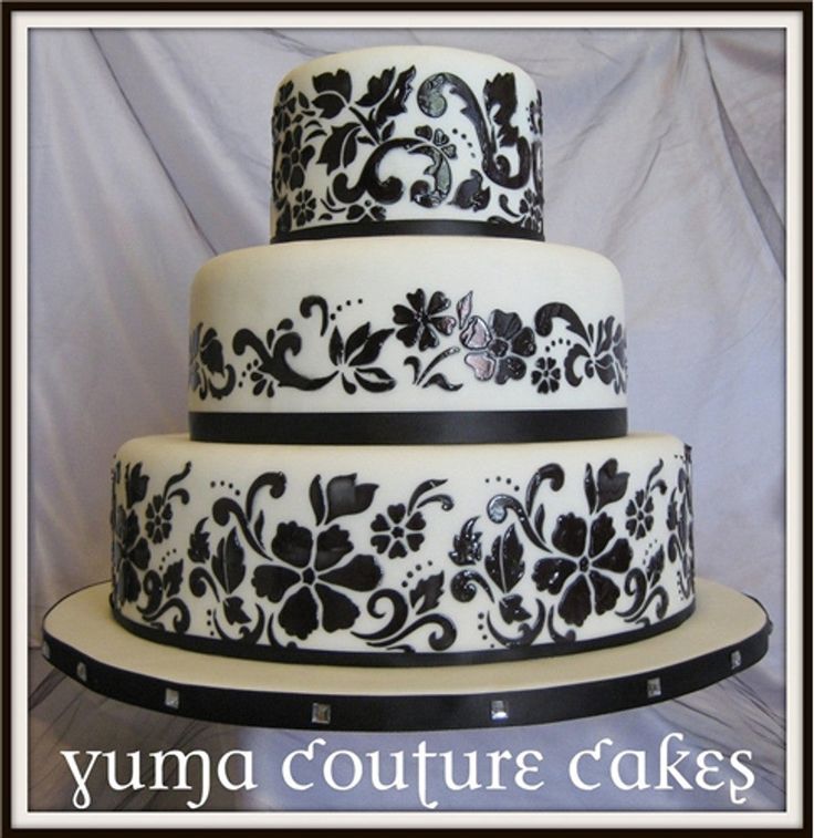 a three tiered cake with black and white designs