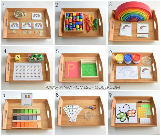 several wooden trays filled with different types of crafts and activities for kids to make