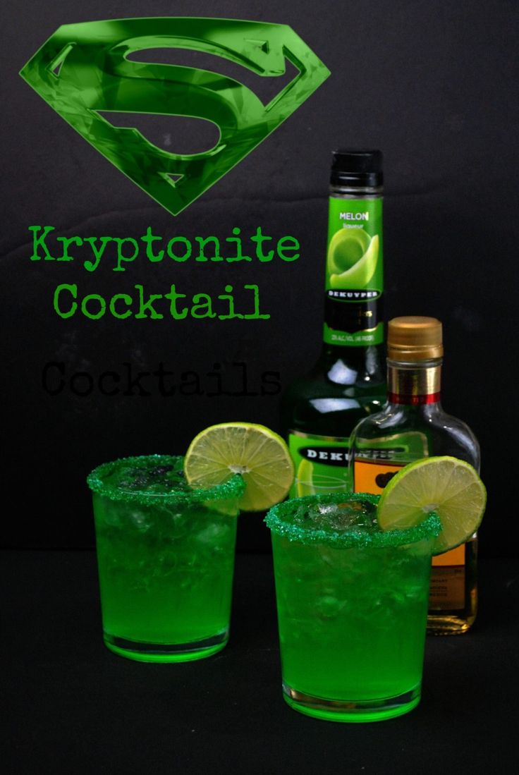 two glasses filled with green liquid and limes next to a bottle of alcohol,