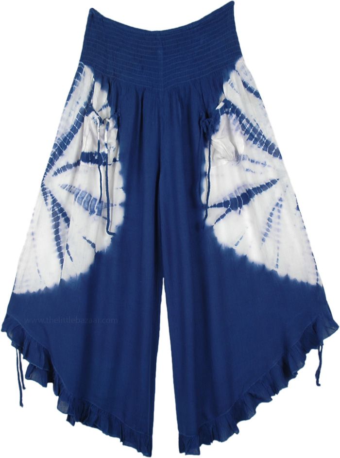 A cropped wide-leg pants featuring smocked elastic waistband, 2 front tie pockets, and ruffle leg opening with tie-ups at the bottom of these pants and can be pulled to make the leg opening higher. A chic pair of wide-leg culotte pants in navy blue with a white tie-dye that goes around the middle of the pants, back, and front. The fabric is slightly crinkled rayon perfect for the hot summer season. Blue Hippie Cotton Pants, Blue Bohemian High-waisted Harem Pants, Bohemian Blue Wide-leg Harem Pants, Blue Bohemian Wide-leg Harem Pants, Hippie Cotton Tie-dye Bottoms, Navy Clothing, Bridesmaids Outfits, Anne Boonchuy, Gold Shirt