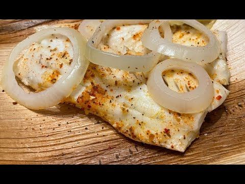 an image of some food that is on a cutting board with onions and cheese in it