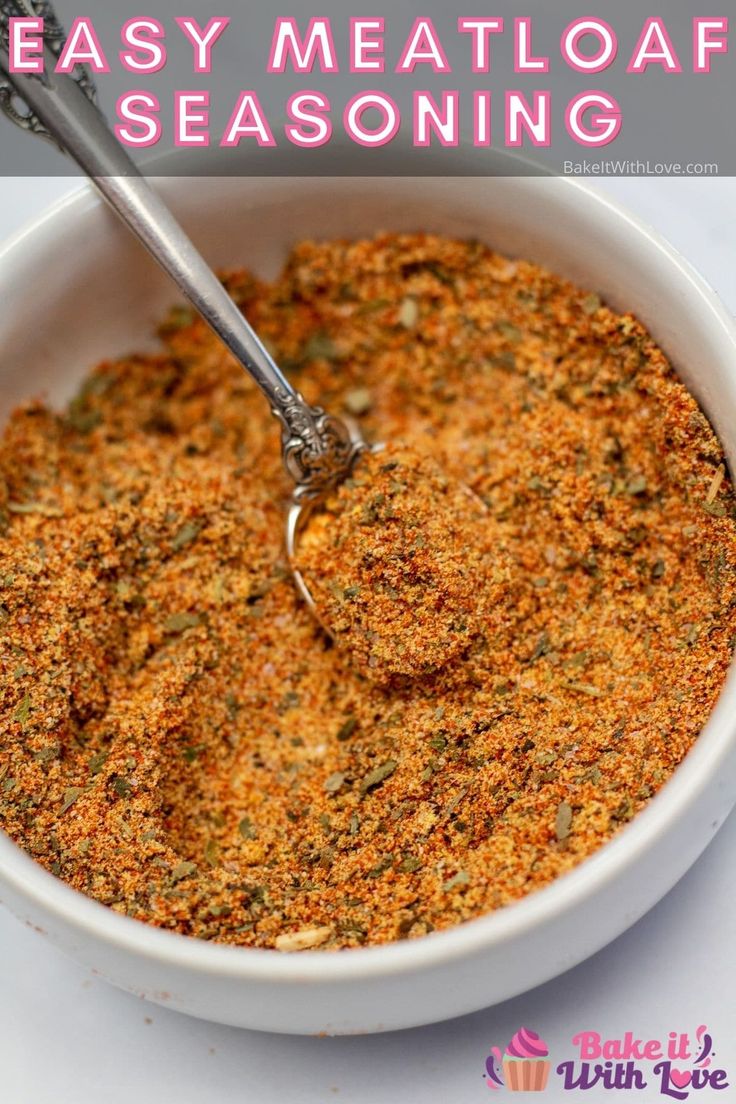 a white bowl filled with seasoning next to a spoon