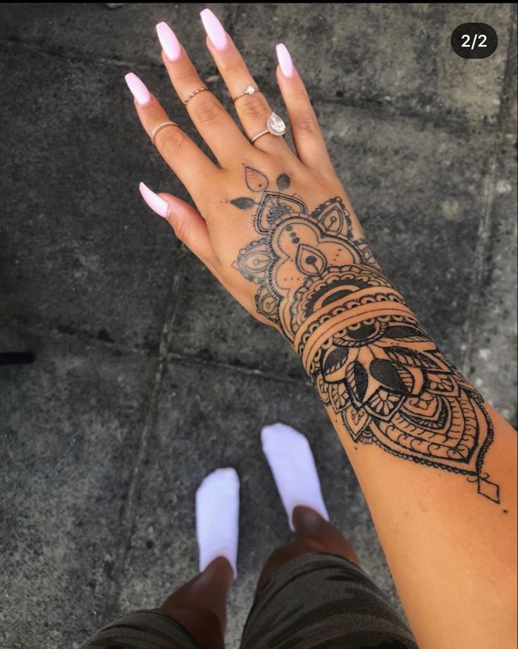 a woman's arm with a tattoo on it and her hand in the air