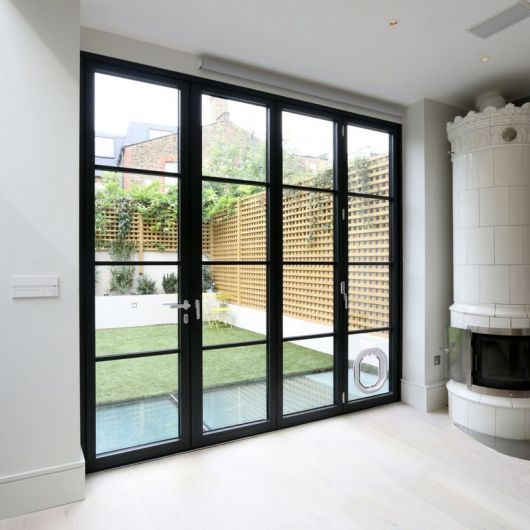 an empty room with sliding glass doors and a fireplace