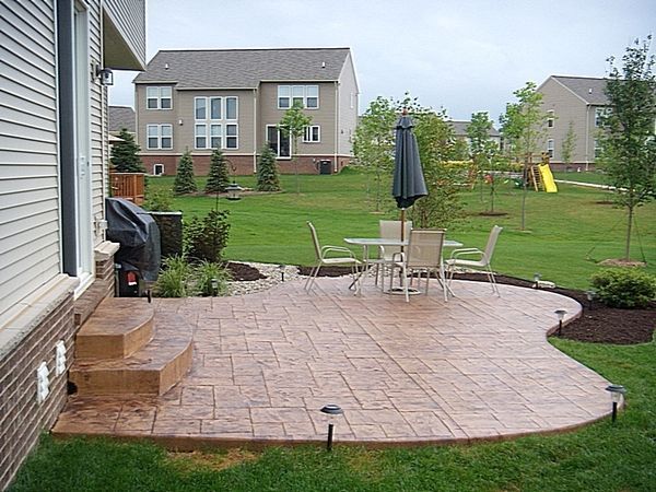 a patio with steps leading up to an outdoor dining area