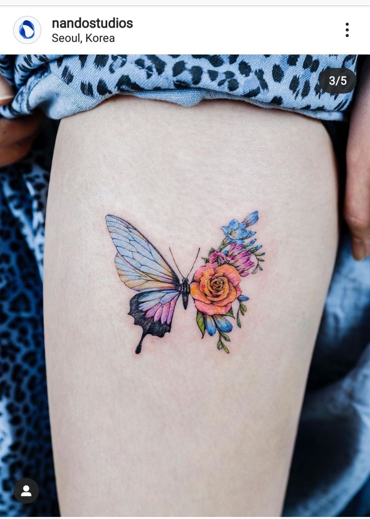 a woman's thigh with a flower and butterfly tattoo on it