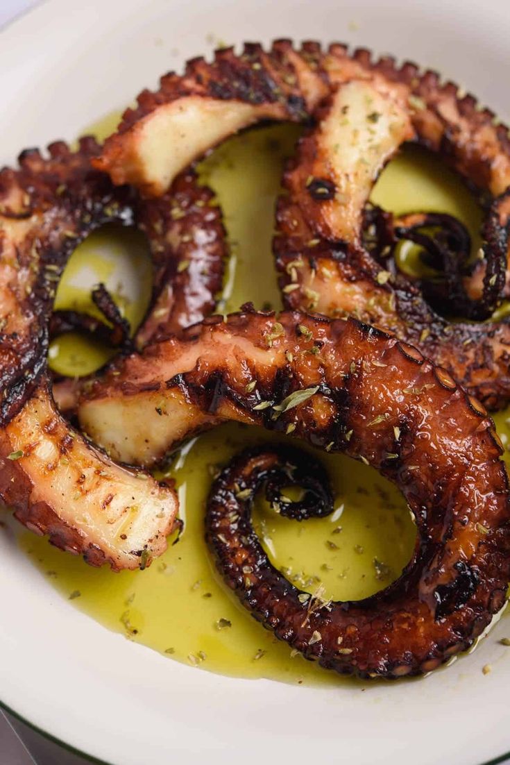 octopus rings with olive sauce on a white plate