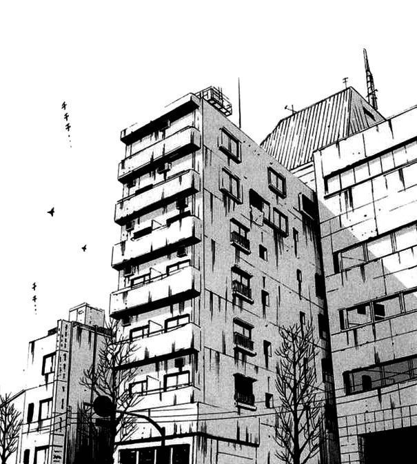 black and white photograph of an apartment building with birds flying in the sky above it