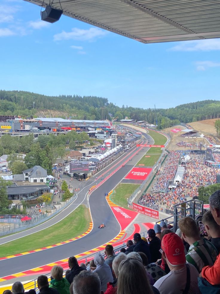 an aerial view of a race track with lots of people sitting on the sidelines