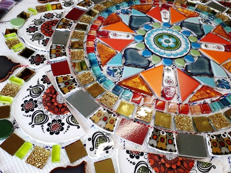 a table topped with lots of different colored plates