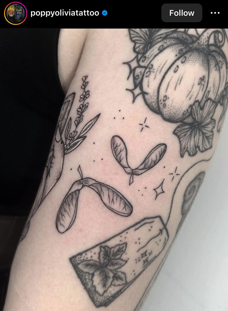 a woman's leg with tattoos on it and some pumpkins in the background