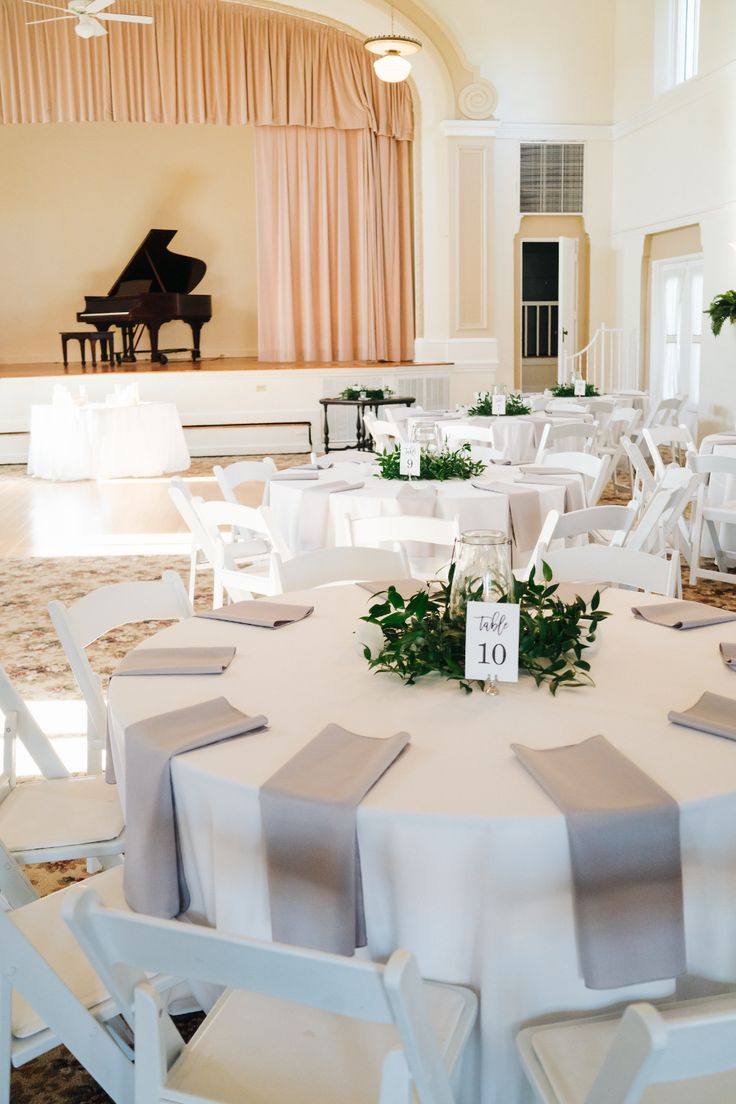 tables and chairs are set up for a formal function at the grand ballroom with piano in the background