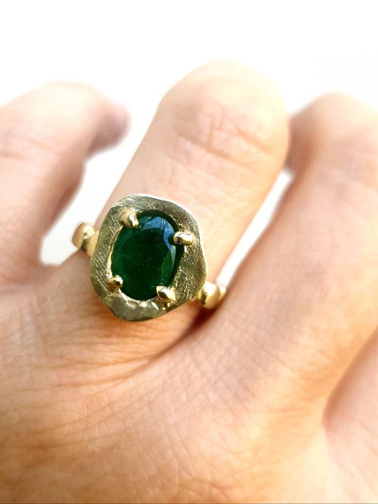 This is a 14 karat gold ring with an oval green emerald gem. Its a beatifull delicate ring that can be used as an anniversary or engagement ring, or a gift for yourself, or for a loved one. ITEM DETAILS Material: The ring is made of 14 karat gold and set with an oval green emerald. Sizes: you can order this ring in sizes 6-9. All my jewelry are sent in a black carton monogramed gift box. Free shipping Please note that you may be charged taxes by your country's customs, please check this before y Emerald Oval Cabochon Ring As A Gift, Yellow Gold Emerald Ring Oval Cabochon, Yellow Gold Emerald Ring With Oval Cabochon, Heirloom Green Emerald Oval Cabochon Ring, Heirloom Green Oval Cabochon Emerald Ring, Oval Emerald Ring With Bezel Setting, Heirloom Oval Cabochon Emerald Ring, Oval Green Signet Ring For Wedding, Green Oval Signet Ring For Wedding