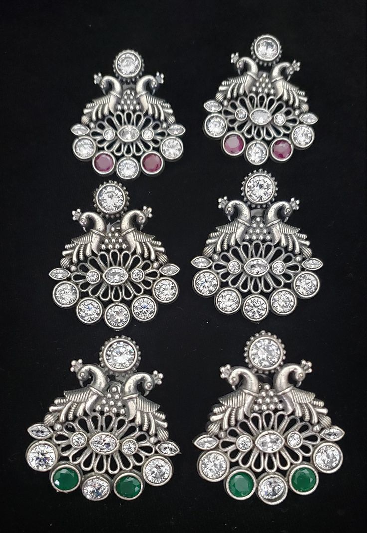 These Jhumka Earrings set have an excellent finish and gives out an exquisite sense of style. If you are looking for an amazing Fashion Jewelry set for special occasions such as Anniversary, Engagement, Party, Wedding or for gifting , then your search ends here. Handmade Indian Temple Jewelry, best to wear it for traditional ceremonies or Indian wedding. This bridal jewelry has ethnic finish. It has Cubic Zircon stones with ruby and emeralds. It is a Bollywood style one gram jewelry. There are l Silver Peacock Design Jewelry Sets For Festivals, Silver Hand Set Temple Jewelry Danglers, Elegant Silver Jewelry Sets With Peacock Design, Silver Peacock Design Jewelry Sets For Wedding, Elegant Silver Chandbalis With Peacock Design, Silver Jewelry Sets With Peacock Design For Wedding, Bollywood Silver Jhumkas With Peacock Design, Silver Temple Jewelry Danglers With Stone Work, Silver Peacock Chandbali Bridal Earrings