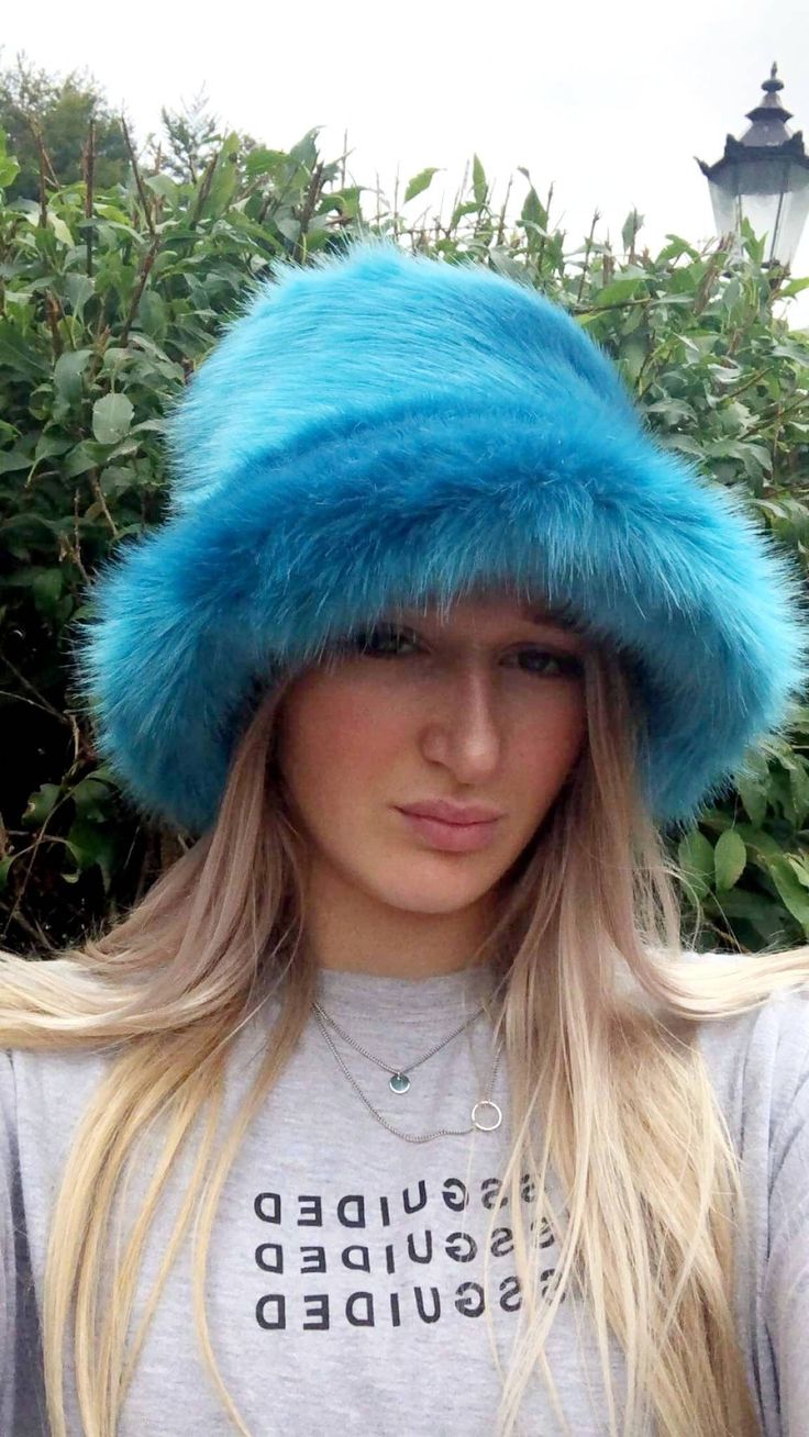 💥My hats are made by me and shipped to you WITHIN 3 days of receiving your order!Welcome to my fluffy shop where absolutely everything is made by me in England!  So because I make everything, any head size can be accommodated for, no worries at all! The standard size will fit heads approx 22- 23.5 inches, but if you want me to make a larger or smaller one, please add a measurement when ordering. Or message me your size.A beautiful super luxury faux fur in this stunning Peacock Blue. Very soft shiny short pile. Hat fits heads approx 21.5 -23 inches but I can make one larger or smaller if you like. The added bonus with my hats is that the polar fleece lining is water resistant, so great if caught in a downpour! All handmade by me in Lancashire! Gertrude Mcfuzz, Fuzzy Headband, Rave Hats, Trio Costumes, Fuzzy Bucket Hat, Fluffy Bucket Hat, Blue Bucket Hat, Fur Bucket, Leo Rising