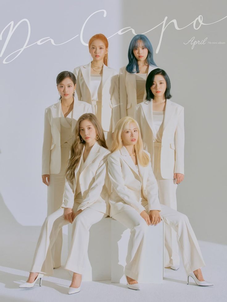 the group of women are posing together for a photo in front of a white background