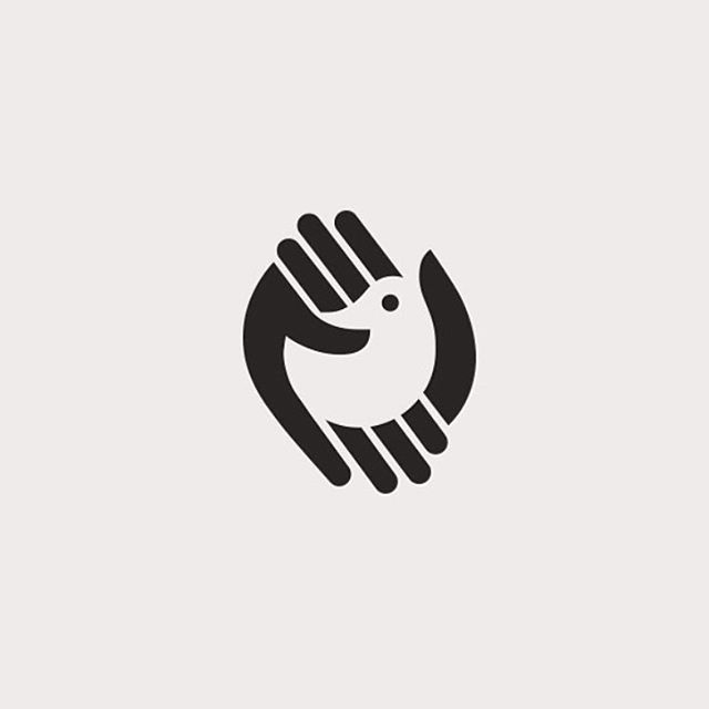 two hands holding each other in the shape of a circle with an animal on it