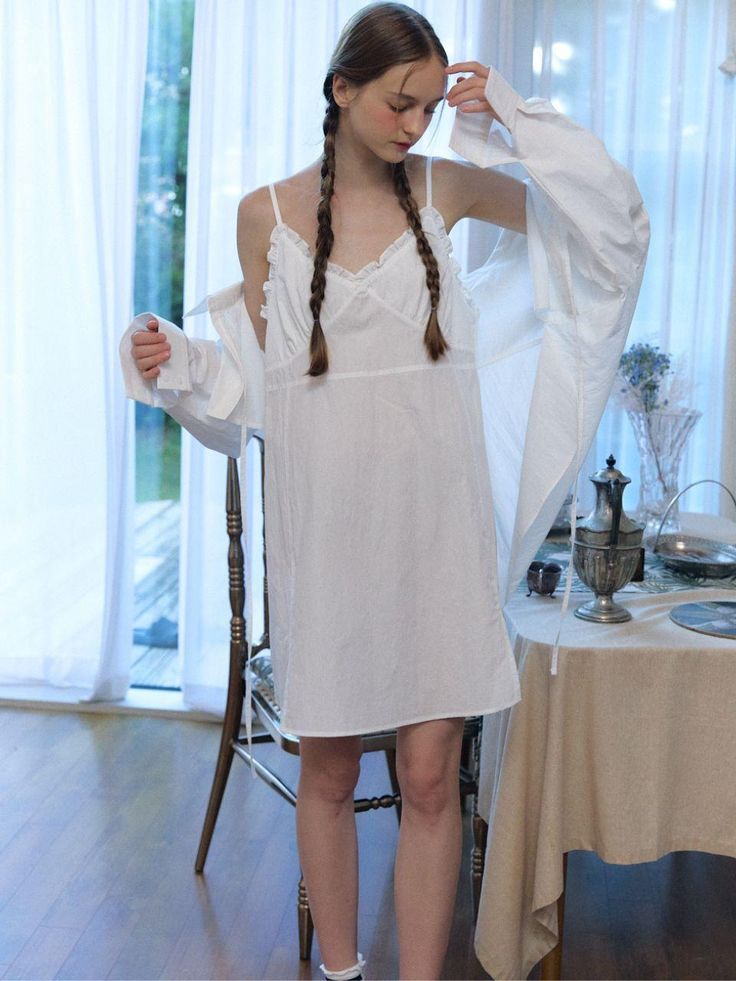 Composition : cotton 100%Color : WhiteCountry of Origin : Republic of Korea Chic Ruffled Sleepwear For Spring, Chic Spring Sleepwear With Ruffles, White Cotton Mini Dress With Ruffles, Cotton Mini Dress For Loungewear, Feminine Cotton Mini Dress With Ruffles, Cotton Mini Dress With Lace Trim For Brunch, White Long Sleeve Chemise For Spring, White Long Sleeve Spring Chemise, Feminine Cotton Mini Dress With Spaghetti Straps